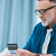 A middle-aged man is shown purchasing a CGM with his FSA card online.