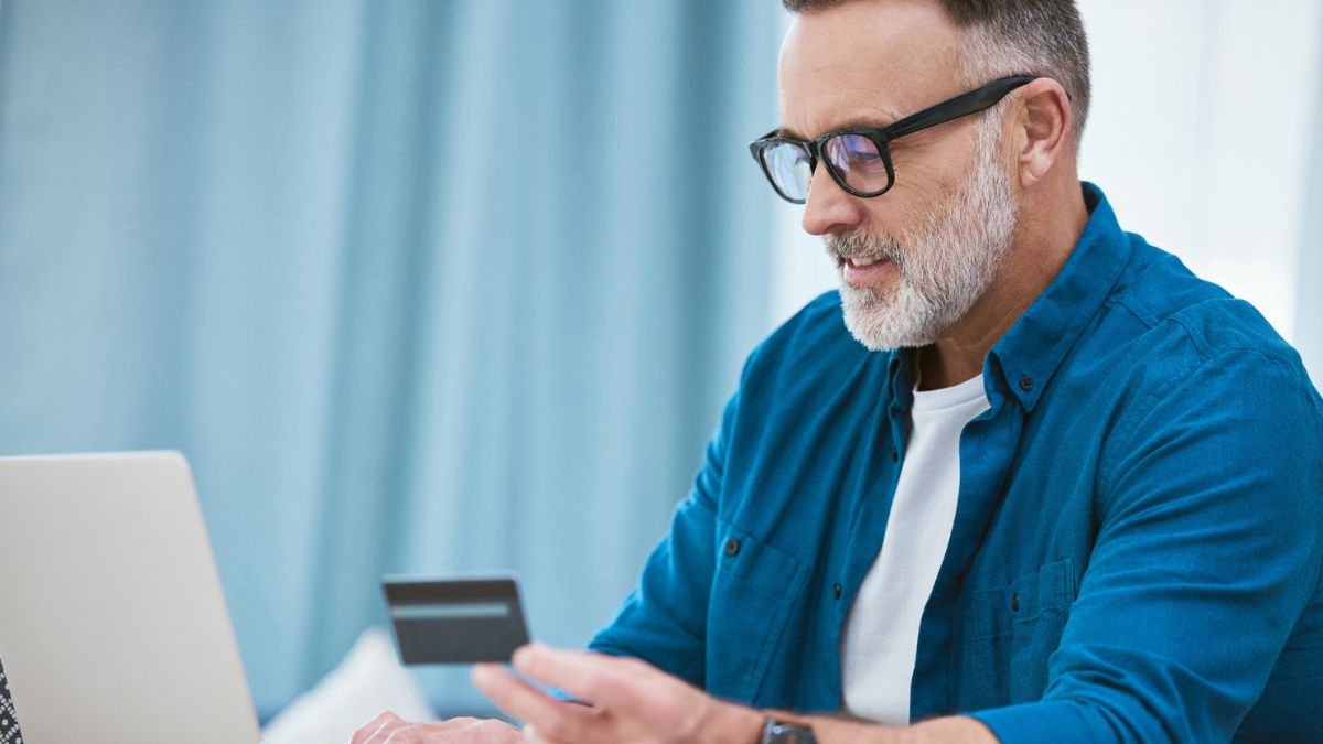A middle-aged man is shown purchasing a CGM with his FSA card online.