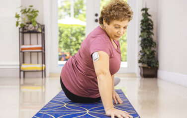 woman checking glucose monitor